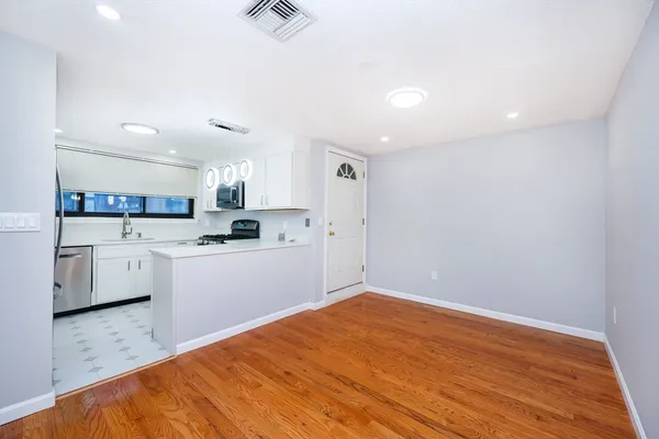 a kitchen with a refrigerator sink and cabinets