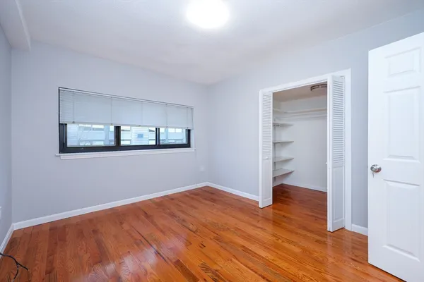 a view of a room with wooden floor and closet