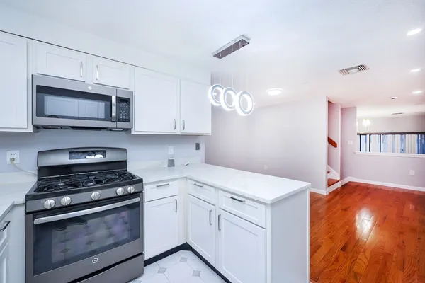 a kitchen with a stove and a microwave