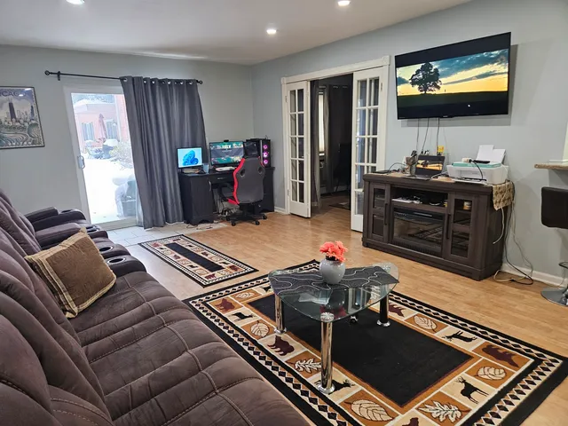 a living room with furniture and a flat screen tv