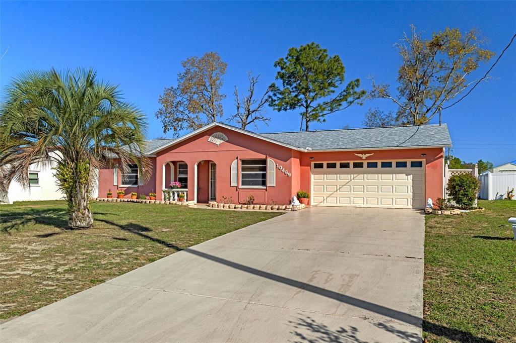 10469 Ireland Street Spring Hill, FL 34608 - Photo 1 of 1 a view of a house with a yard