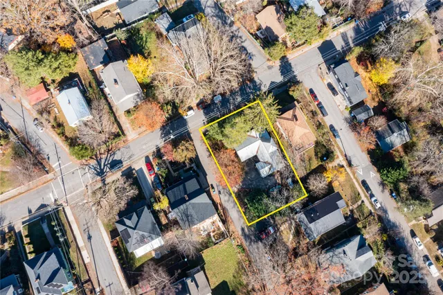 an aerial view of a house with a yard and garden
