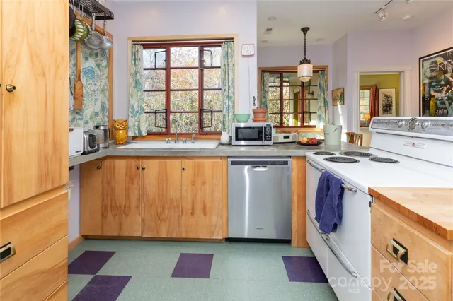 a kitchen with stainless steel appliances granite countertop a sink and a stove