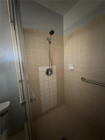 a view of a livingroom with a projector and stairs