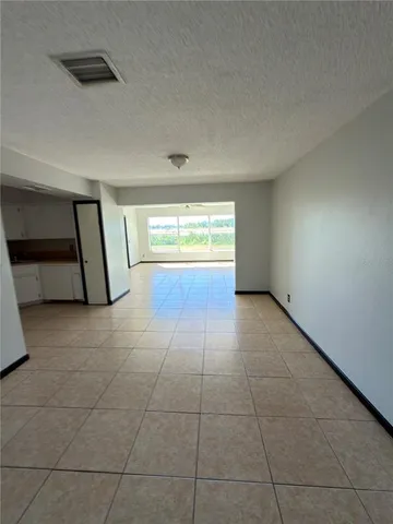 a view of a kitchen with an empty space and window