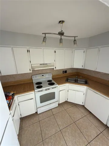a kitchen with cabinets and appliances