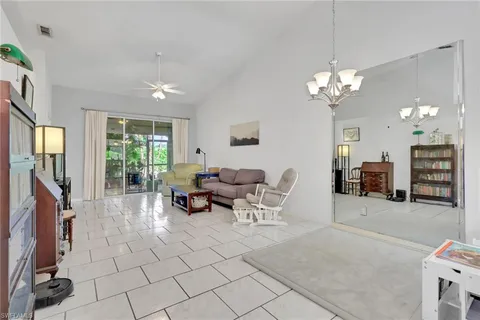 a living room with fireplace furniture and a flat screen tv