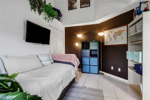 a bedroom with a large bed and a flat screen tv