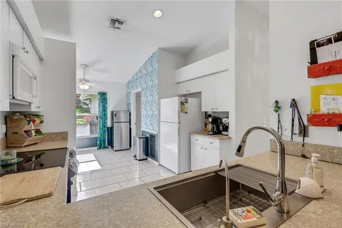 a kitchen with stainless steel appliances granite countertop a sink refrigerator and microwave