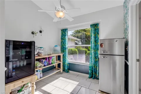 a view of kitchen with refrigerator and window