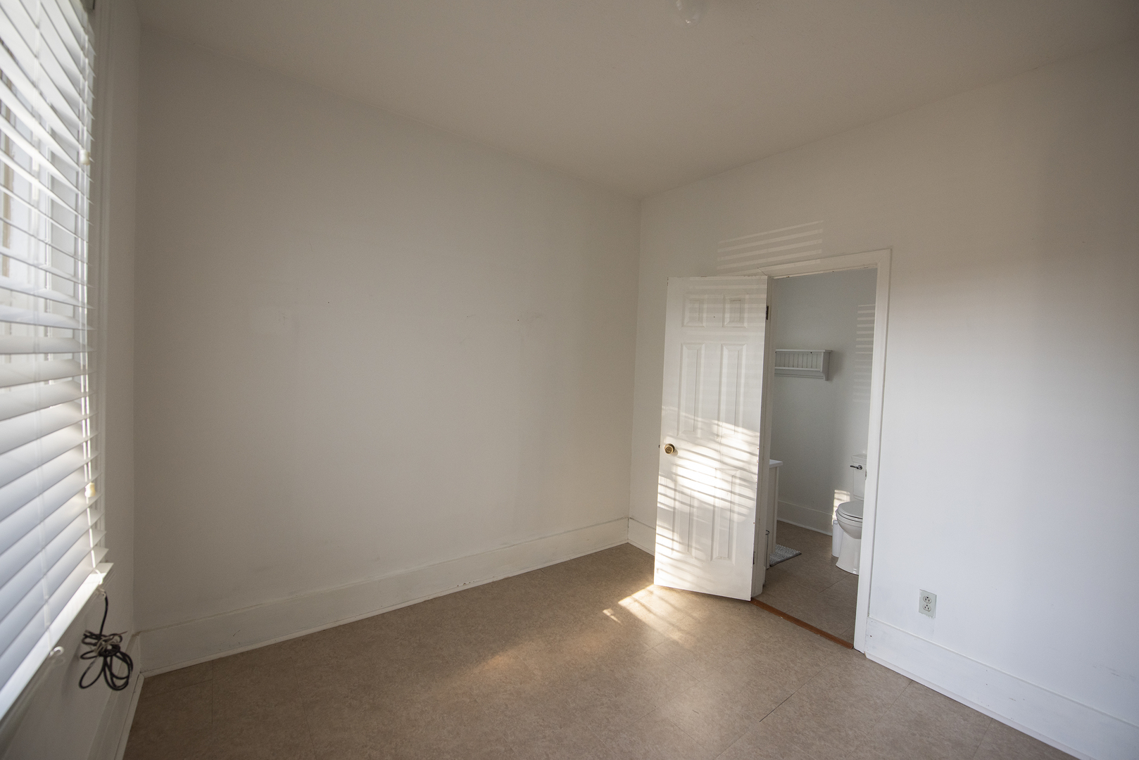 716 Locust Street Sterling, IL 61081 - Photo 13 of 27 an empty room with an entryway and a window