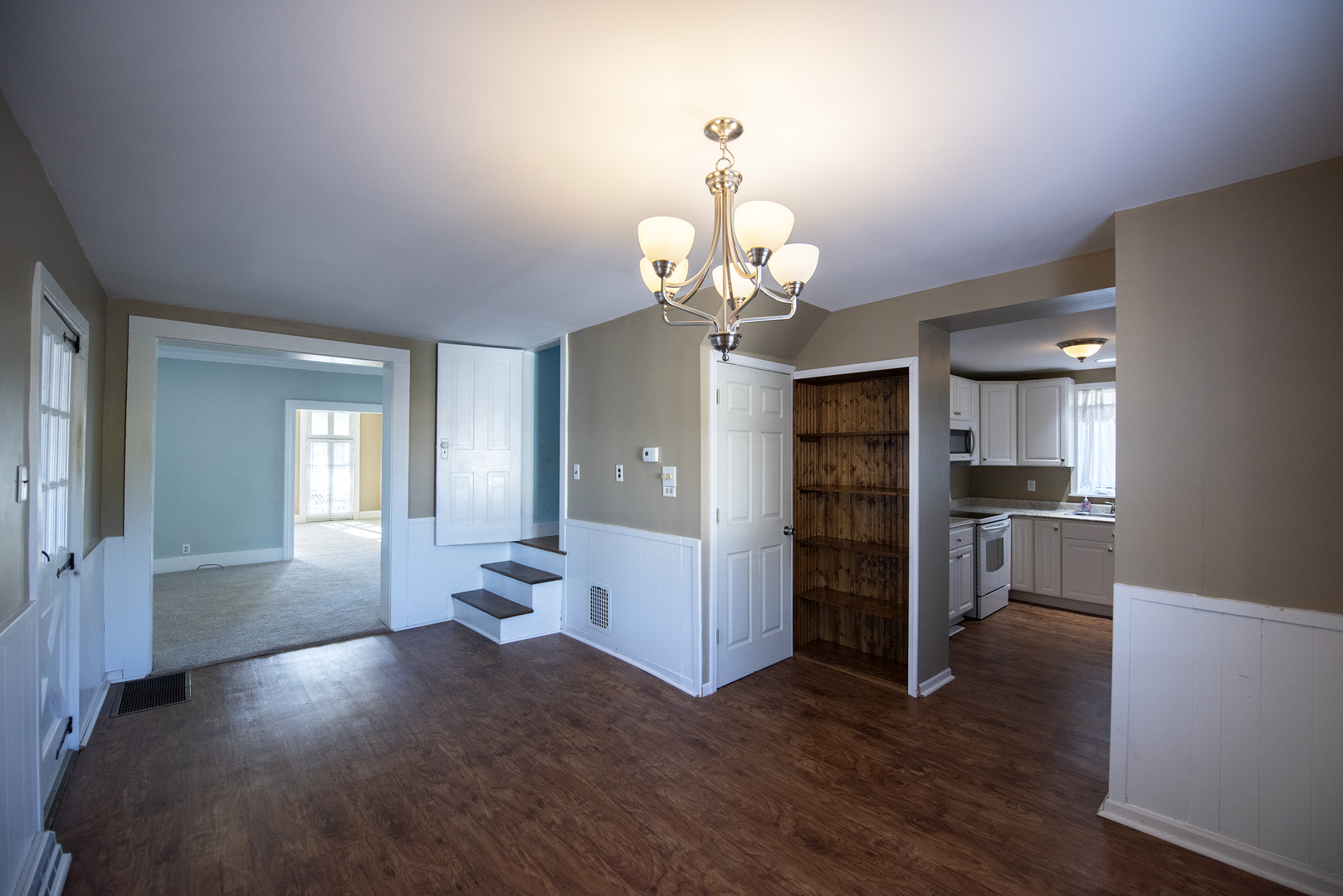 716 Locust Street Sterling, IL 61081 - Photo 15 of 27 a view of a livingroom with wooden floor and staircase