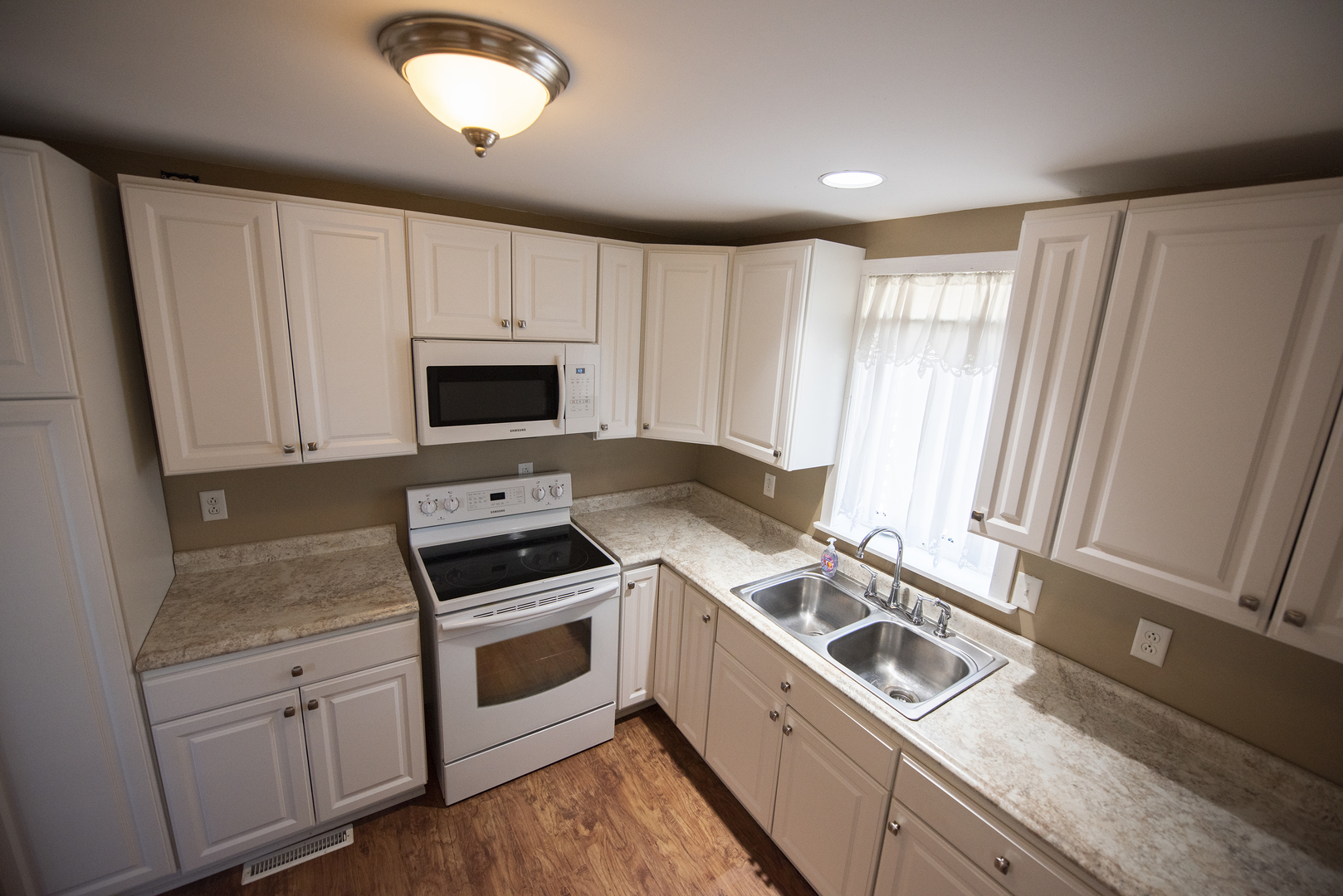 716 Locust Street Sterling, IL 61081 - Photo 16 of 27 a kitchen with a stove and a sink