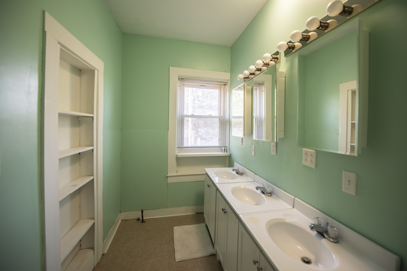 716 Locust Street Sterling, IL 61081 - Photo 21 of 27 a bathroom with a sink mirror and a window