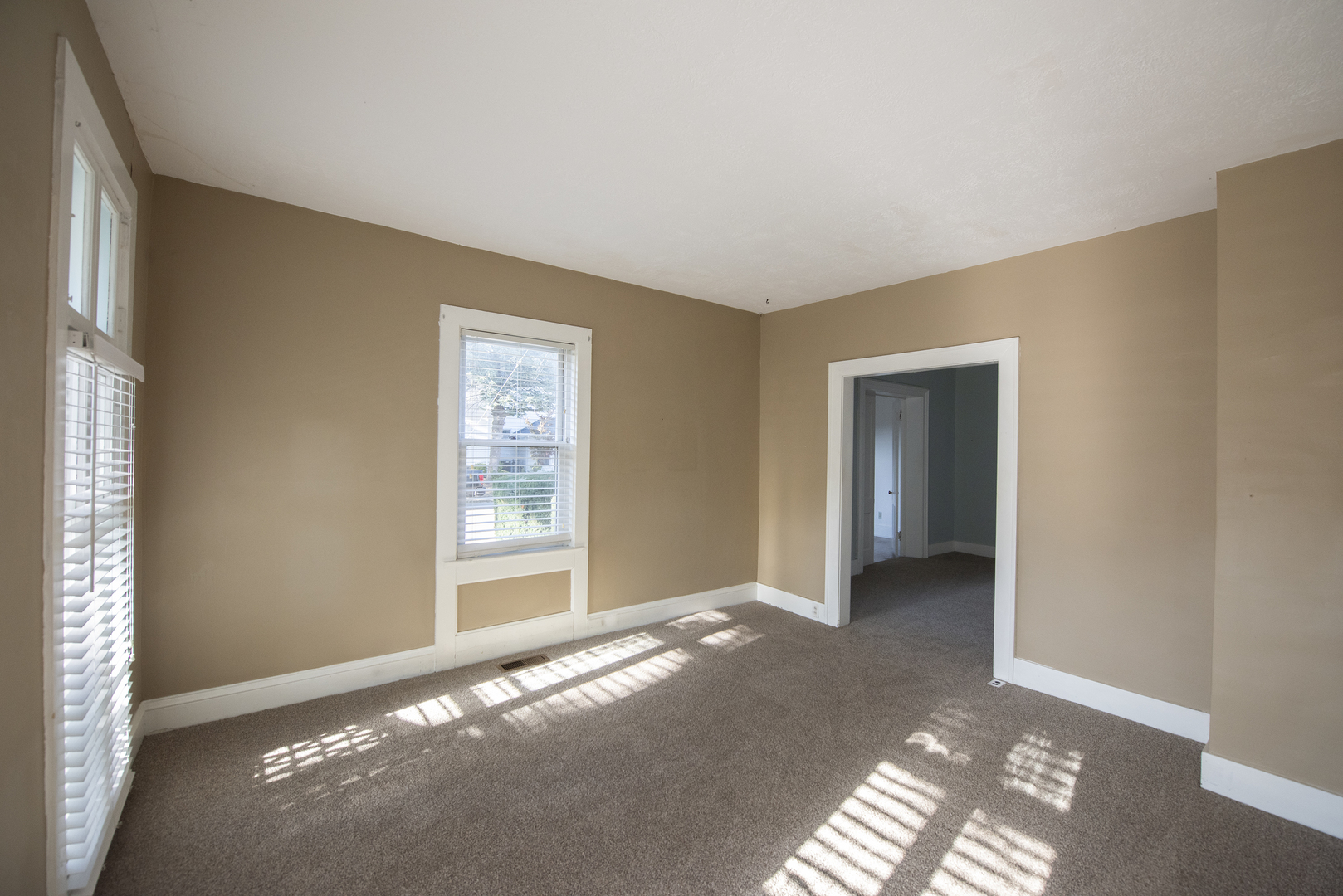 716 Locust Street Sterling, IL 61081 - Photo 9 of 27 a view of a big room with windows and entryway