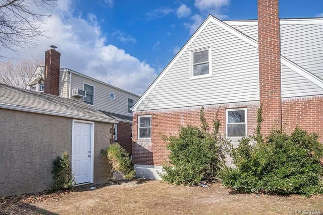 a view of a house with potted plants