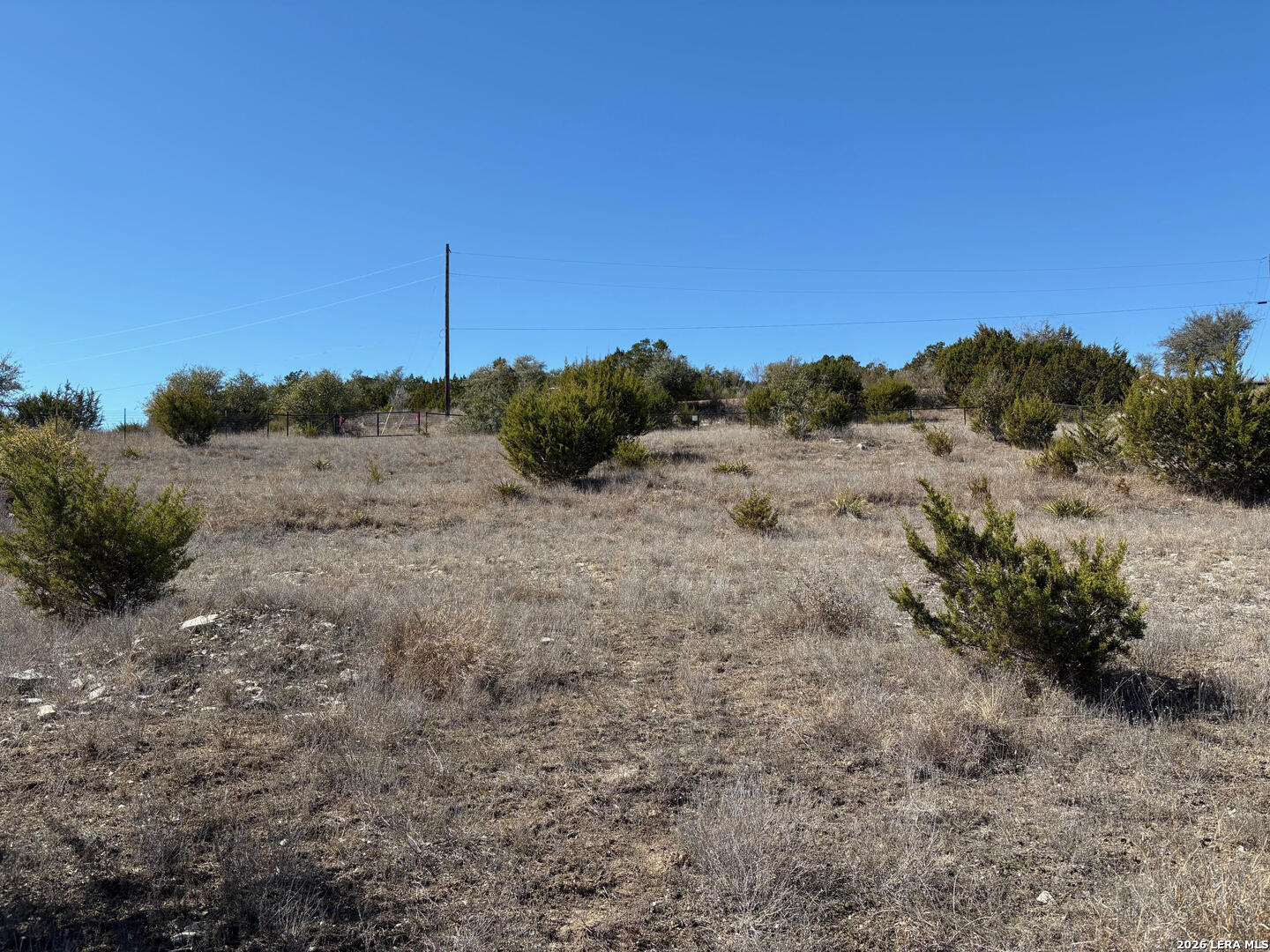 552-lot 2002) Rock Trail Spring Branch, TX 78070 - Photo 15 of 39 a view of a dry field with trees in the background