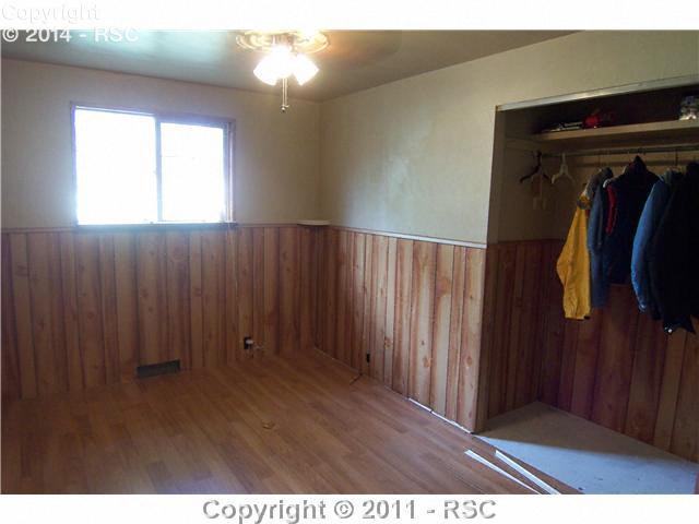 15190 Davis Road Peyton, CO 80831 - Photo 9 of 16 Bedroom Two has newer flooring, ceiling fan and large closet.