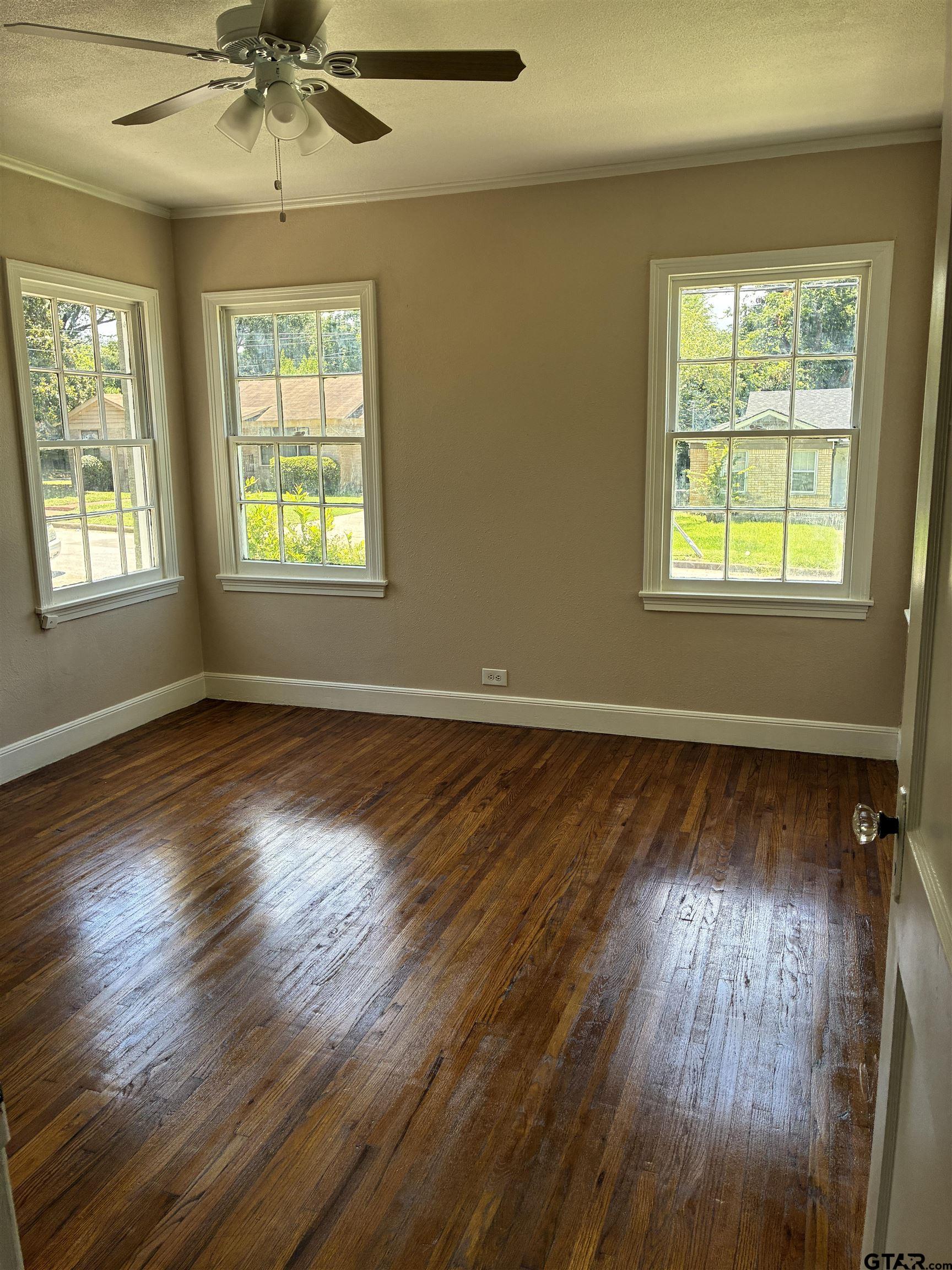 811 West 5th Street Tyler, TX 75701 - Photo 12 of 26 a view of an empty room with wooden floor and a window
