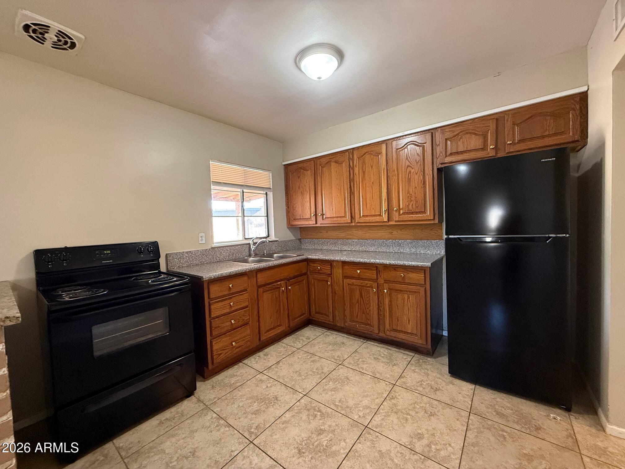4447 East Almeria Road Phoenix, AZ 85008 - Photo 4 of 9 a kitchen with a refrigerator and a stove