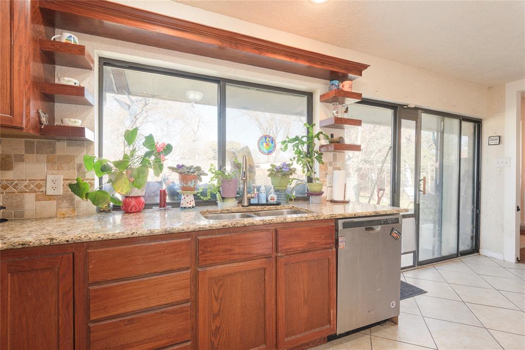 2005 Inverness Drive Carrollton, TX 75007 - Photo 12 of 25 a kitchen with sink and large window