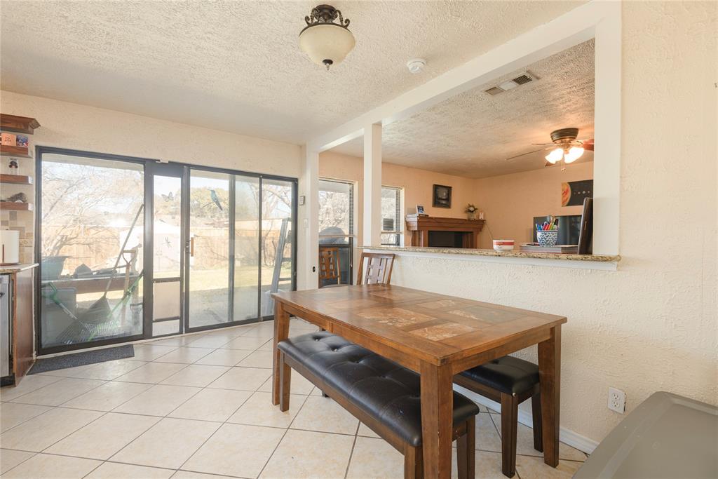 2005 Inverness Drive Carrollton, TX 75007 - Photo 14 of 25 a dining room with a table and chairs