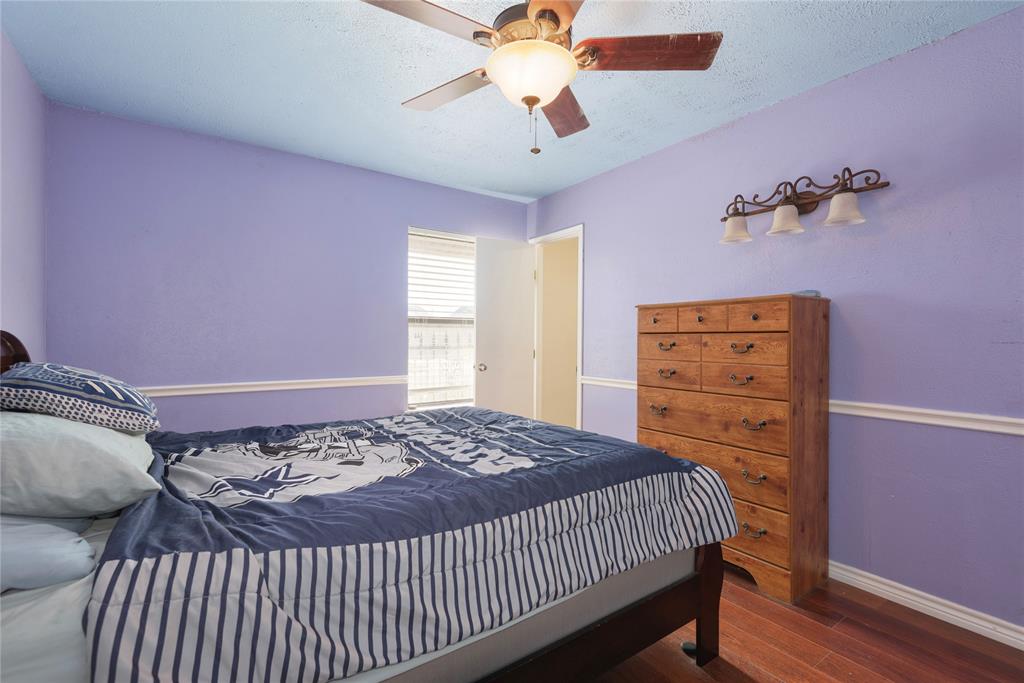 2005 Inverness Drive Carrollton, TX 75007 - Photo 17 of 25 a bedroom with a bed and a chandelier