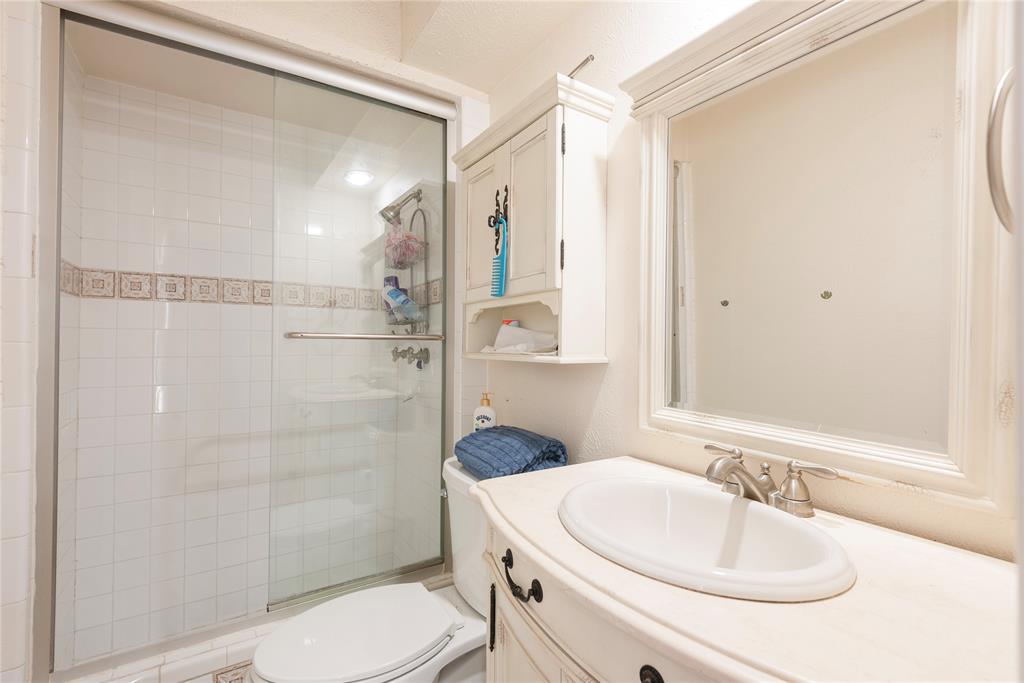 2005 Inverness Drive Carrollton, TX 75007 - Photo 18 of 25 a bathroom with a sink toilet and shower