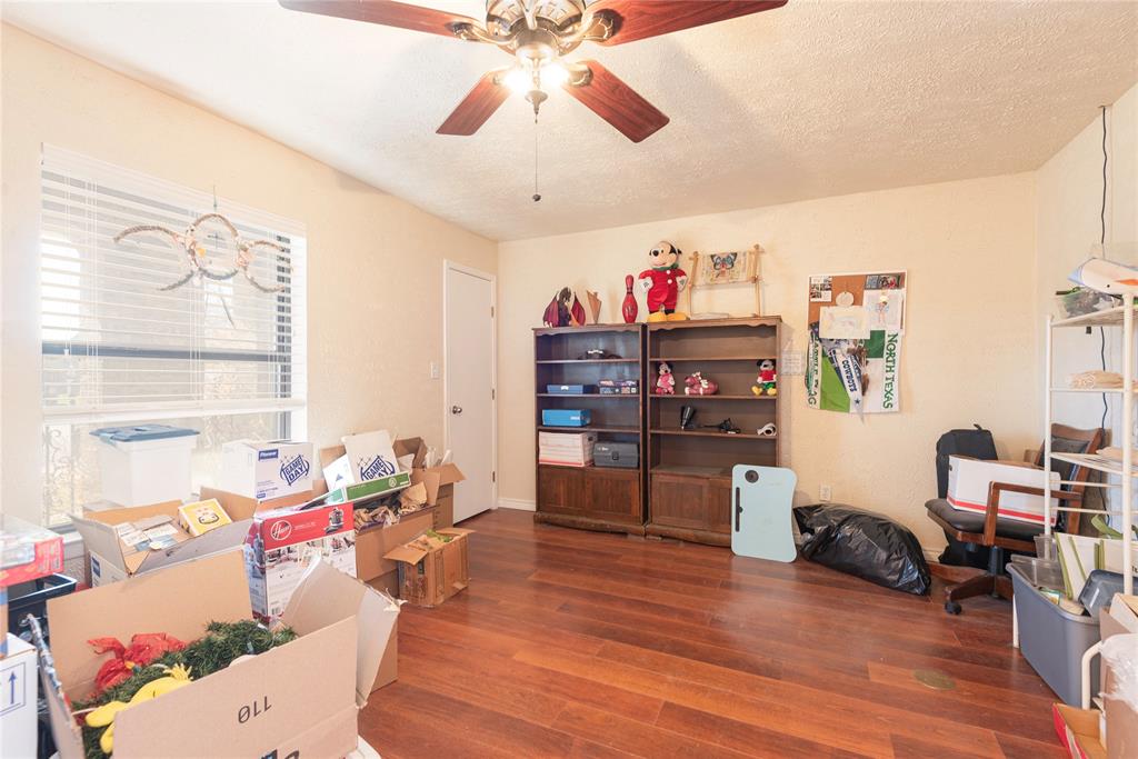 2005 Inverness Drive Carrollton, TX 75007 - Photo 21 of 25 a living room with furniture and a wooden floor