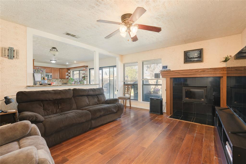 2005 Inverness Drive Carrollton, TX 75007 - Photo 9 of 25 a living room with furniture and a fireplace