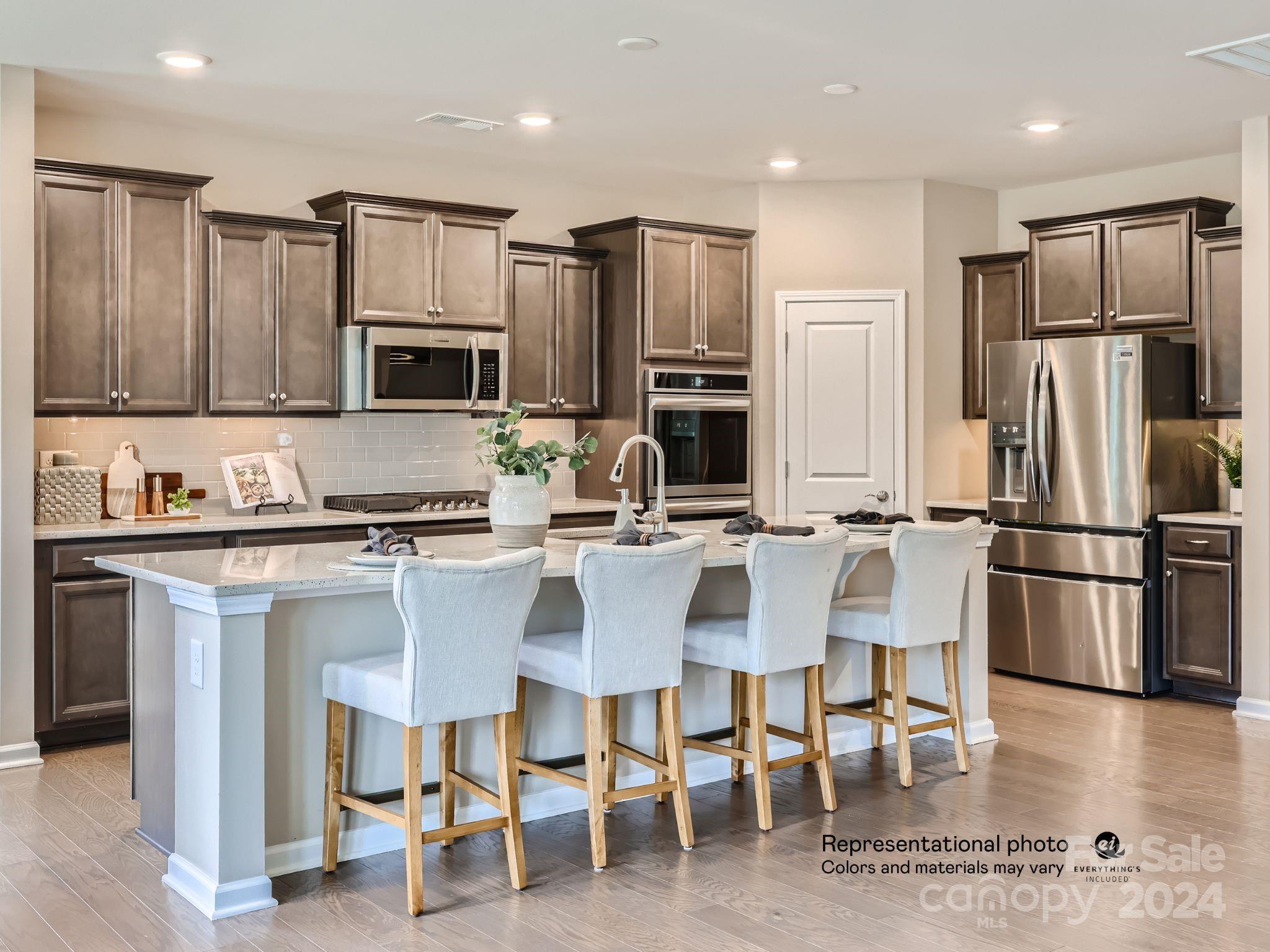4468 Doyle Rdg Road Maiden, NC 28650 - Photo 6 of 16 a kitchen with stainless steel appliances kitchen island granite countertop a refrigerator and microwave