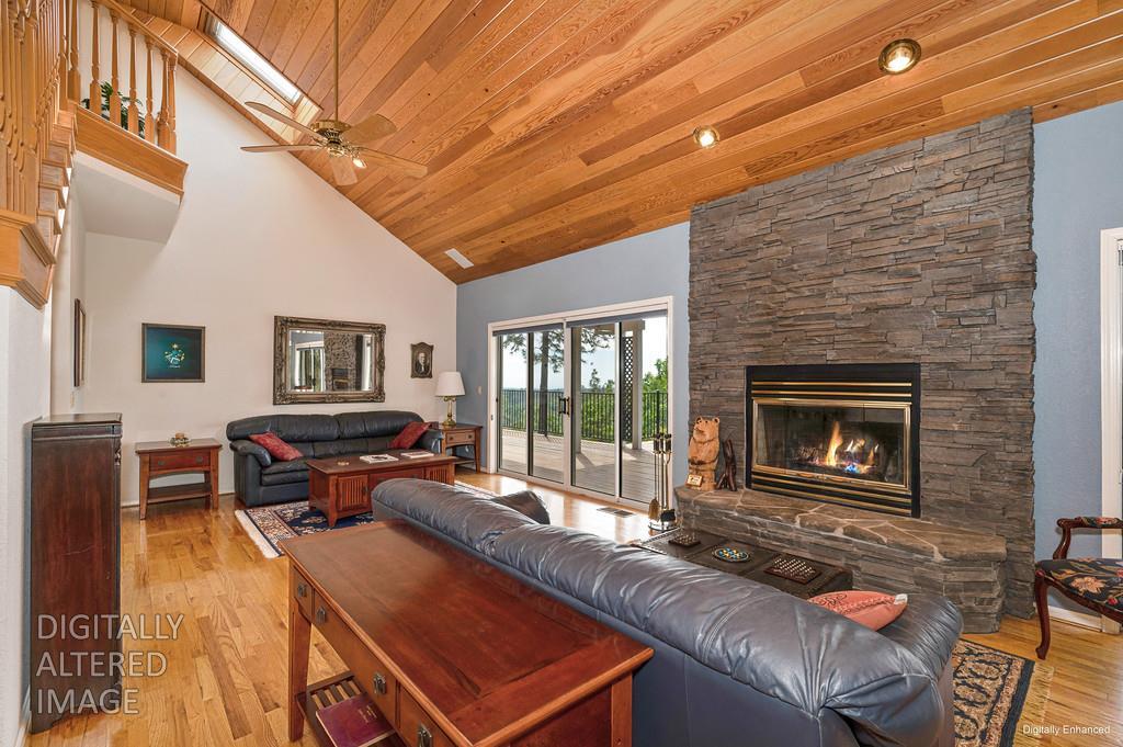2358 Deer Ravine Court Cool, CA 95614 - Photo 13 of 63 living room featuring a fireplace, light wood-type flooring, a vaulted wooden ceiling, and ceiling fan