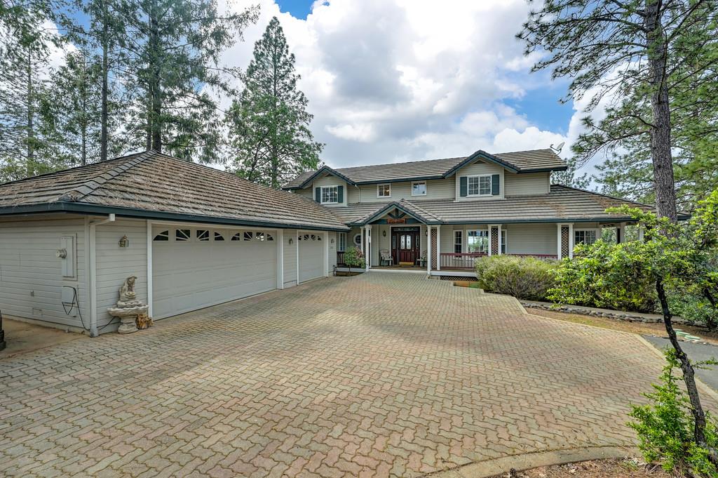 2358 Deer Ravine Court Cool, CA 95614 - Photo 2 of 63 view of front of property with a porch, an attached garage, and decorative driveway