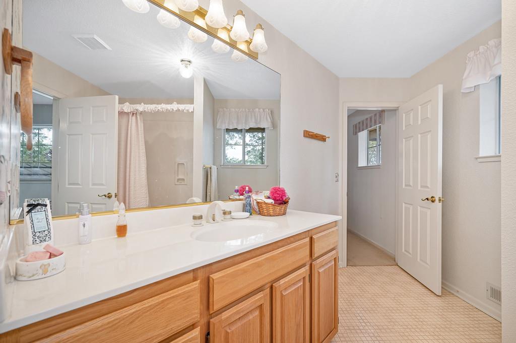 2358 Deer Ravine Court Cool, CA 95614 - Photo 24 of 63 a bathroom with a sink double vanity and a mirror