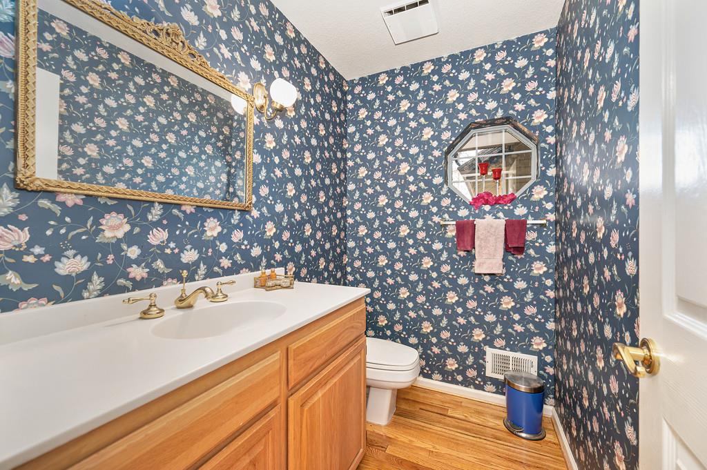 2358 Deer Ravine Court Cool, CA 95614 - Photo 28 of 63 guest bathroom with wallpapered walls, vanity, and light wood-style floors