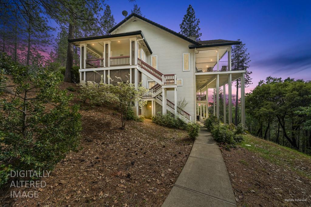 2358 Deer Ravine Court Cool, CA 95614 - Photo 59 of 63 back of house at dusk with stairway and a porch