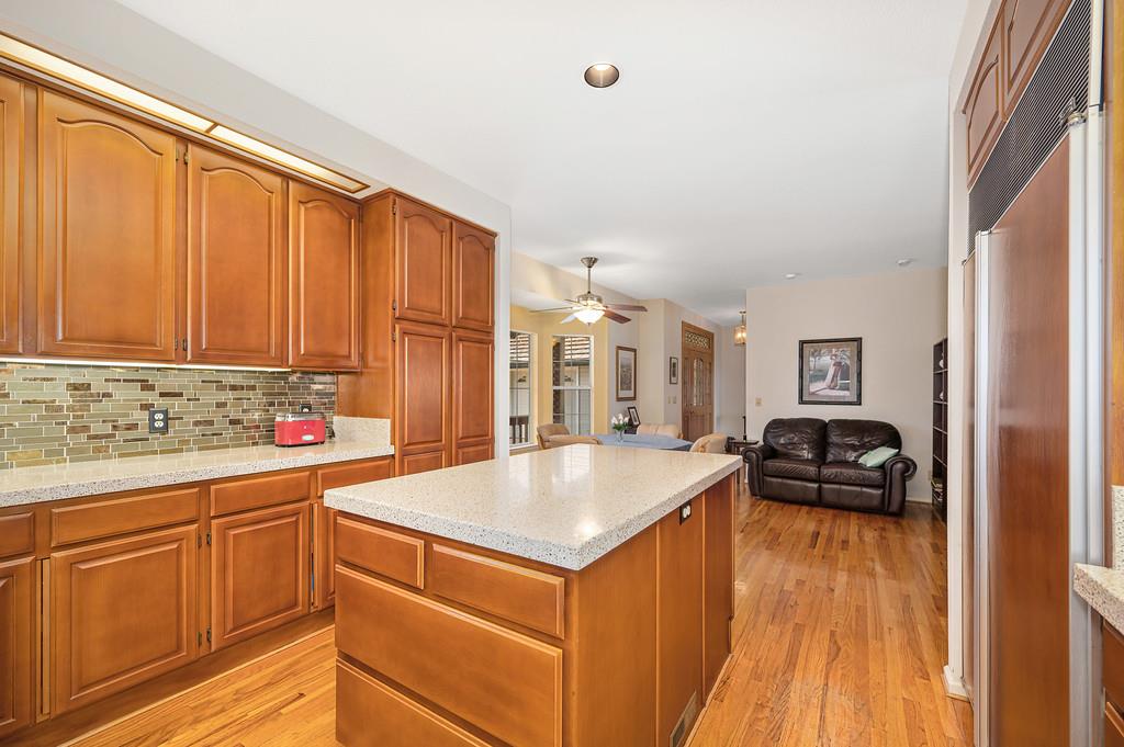 2358 Deer Ravine Court Cool, CA 95614 - Photo 61 of 63 kitchen featuring a kitchen island, wood finish cabinetry, open floor plan, paneled built in fridge, and ceiling fan