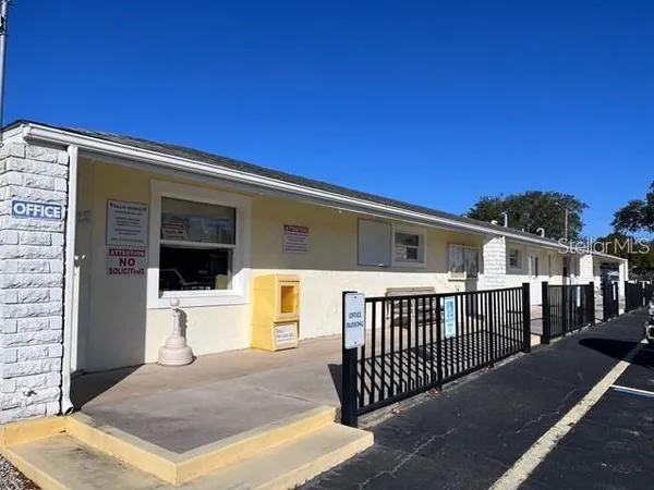 a view of a house with a wooden fence