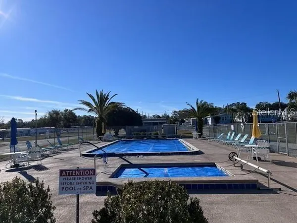 a view of swimming pool with sitting area