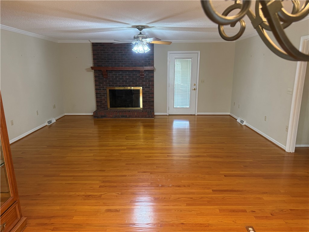 121 Nautical Way Anderson, SC 29625 - Photo 13 of 37 An inviting gathering space features warm wood floors and a stately brick fireplace.