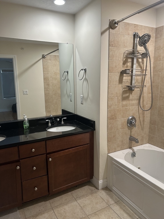 4 Reserve Way, Unit D Burlington, MA 01803 - Photo 12 of 17 a bathroom with a tub sink and mirror