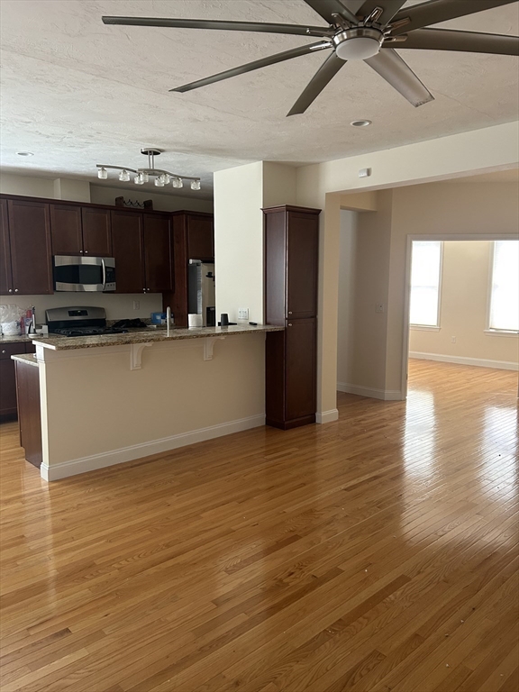 4 Reserve Way, Unit D Burlington, MA 01803 - Photo 7 of 17 a view of kitchen with stainless steel appliances wooden floor and a refrigerator