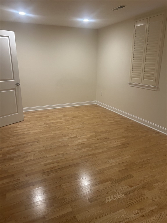 4 Reserve Way, Unit D Burlington, MA 01803 - Photo 10 of 17 an empty room with wooden floor and windows