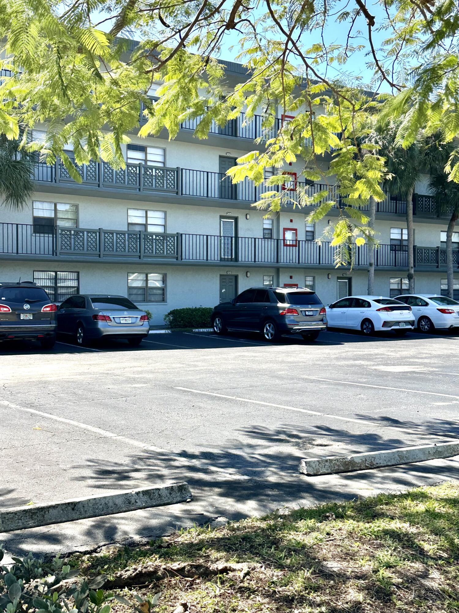 9440 Southwest 8th Street, Unit 109 Boca Raton, FL 33428 - Photo 12 of 14 a view of street with parking