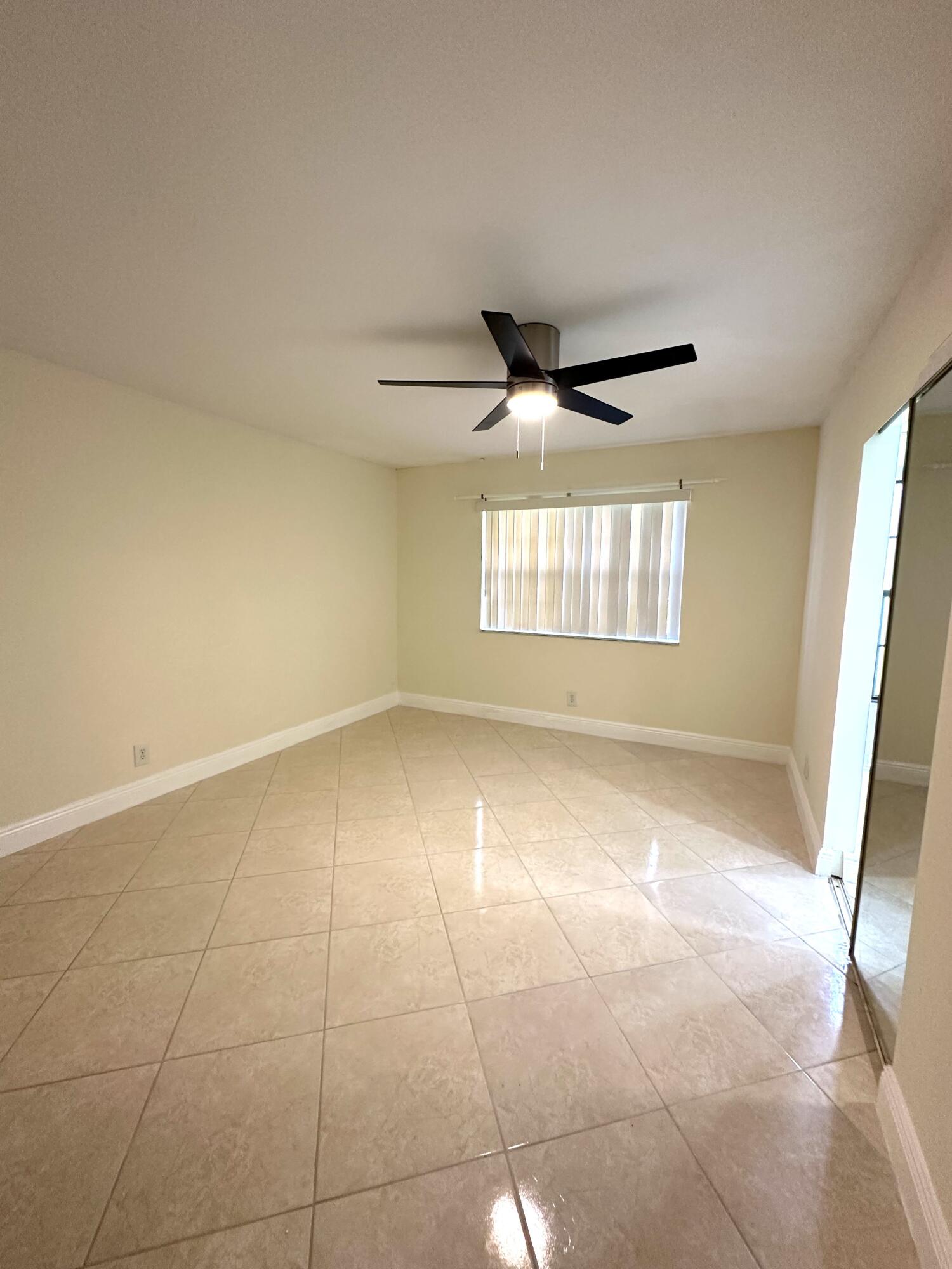 9440 Southwest 8th Street, Unit 109 Boca Raton, FL 33428 - Photo 4 of 14 a view of an empty room with a window