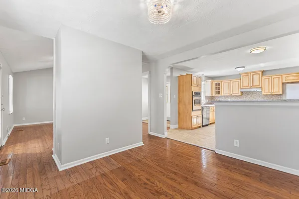 a view of a kitchen with wooden floor and a kitchen
