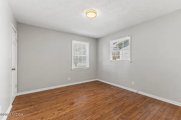 a view of a room with wooden floor and window