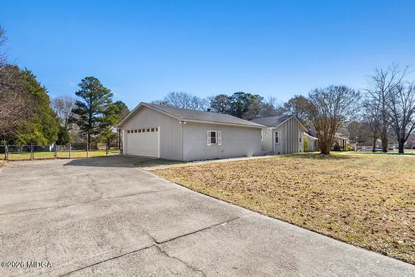a backyard of a house with large trees