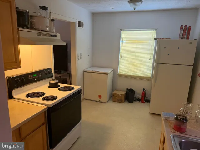 a kitchen that has a sink and a stove