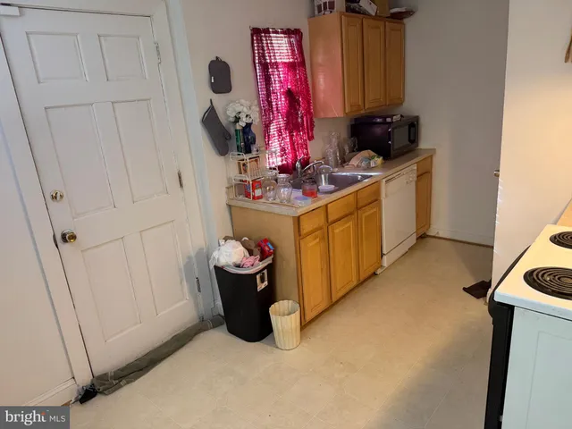a kitchen with stainless steel appliances a stove top oven and cabinets